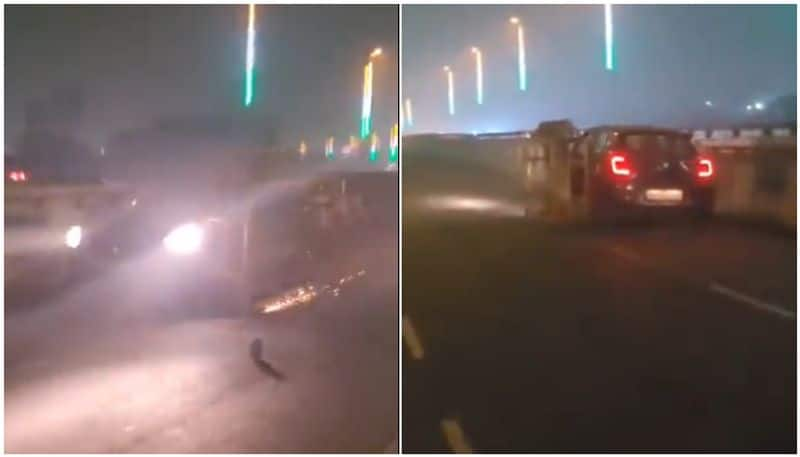 Video shows car dragging Police barricade on flyover viral btb