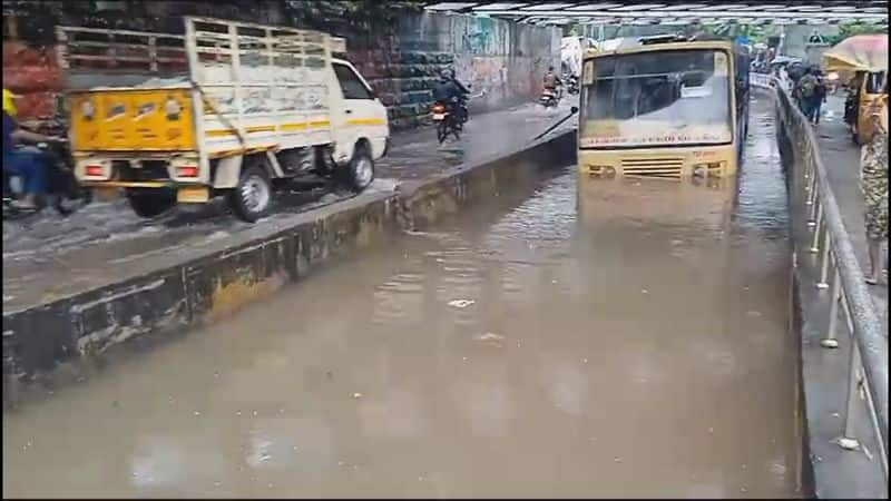 government bus stuck rain water under railway bridge in chennai vel