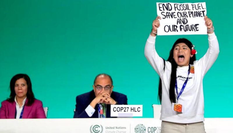 COP28 dubai 12 year old girl storms in stage with holding sign against fossil fuel ans