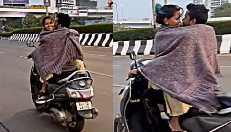 Couple romance on a moving scooty.. Lovers excited on the road with hugs and kisses.. Viral..ISR