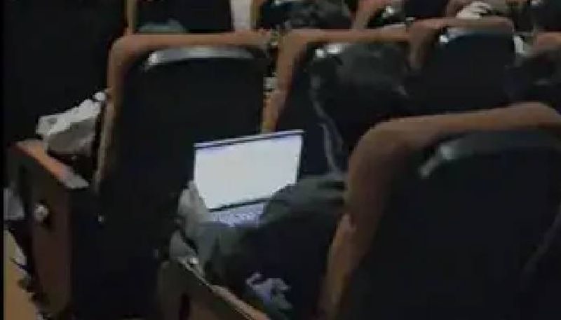 man working with laptop in cinema hall peak bengaluru rlp