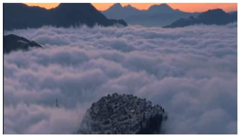 video of an Italian town standing tall amidst floating clouds has gone viral bkg 