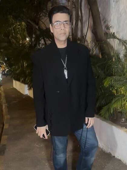 Karan Johar in an oversized black jacket