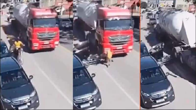 Bike rider fell under the lorry after car occupants opened door without looking back viral video akb