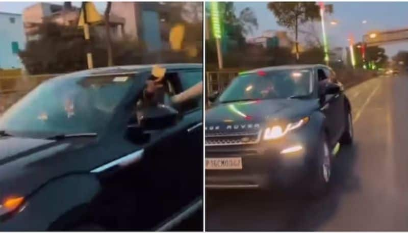 man throws money from car on road police action after the video went viral