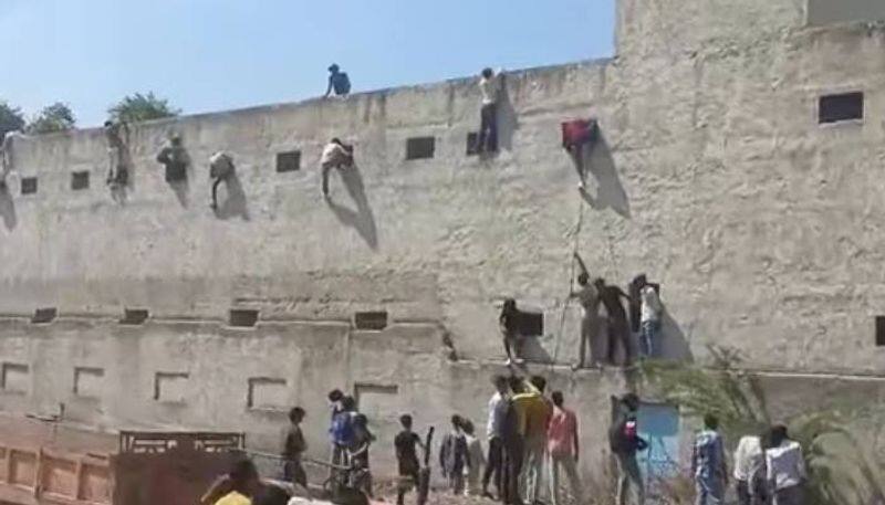 men climbs school walls to help students in exam mass cheating in haryana school video rlp