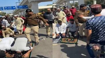 Viral Video Delhi Police Cop was seen hitting and kicking people offering Namaz at road [WATCH] nti