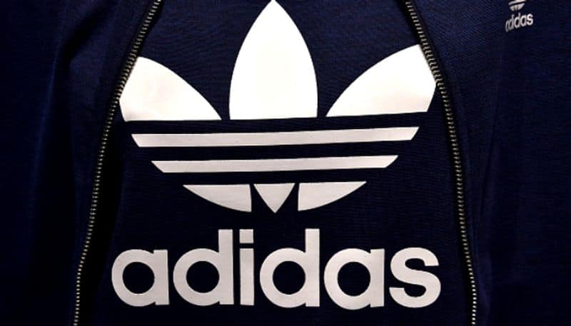 Adidas posts first loss in 30 years and warns on US