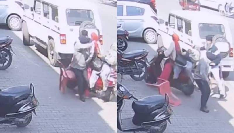 men sitting in roadside woman in scooty crashing video rlp