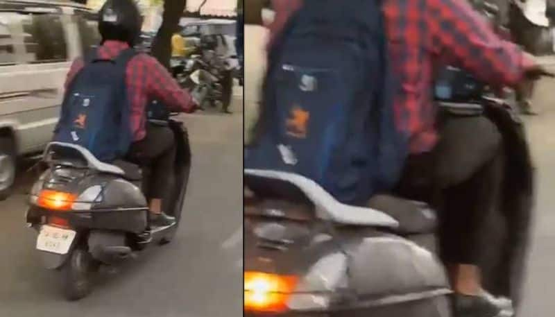 man attending zoom call on laptop while riding scooter video rlp