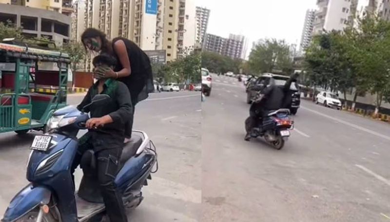 woman stunt on moving scooter in holi day fined by Noida police rlp