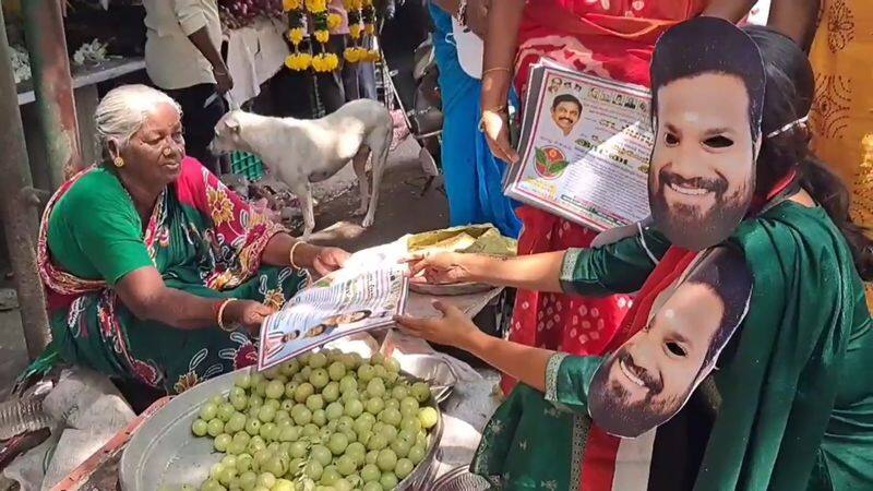 In Puducherry, women wearing masks like the candidate's face campaign for election vel