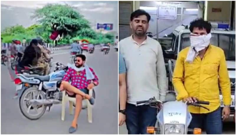 man makes reel sitting on chair In middle of road arrested