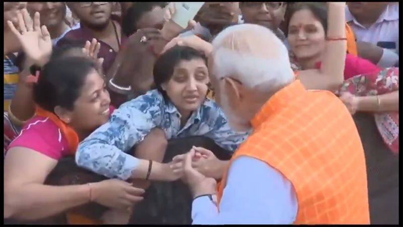 Modi talks with a blind girl after casting his vote in Ahmedabad sgb