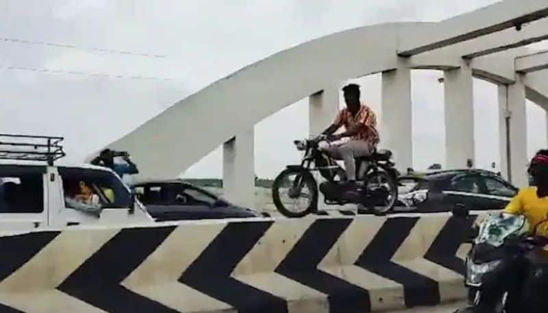 Man conducts Moped bike stunt on divider in Tamil Nadus Trichy police looking for youth  