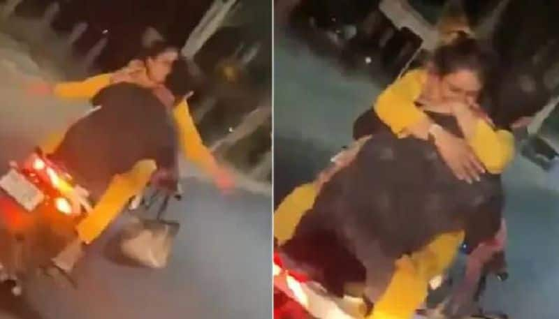 couple romancing in moving bike police file case video 