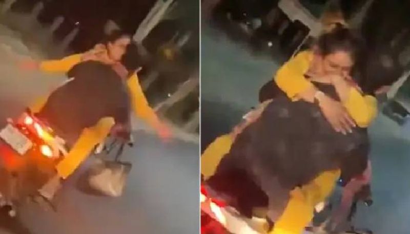 couple romancing in moving bike police file case video 