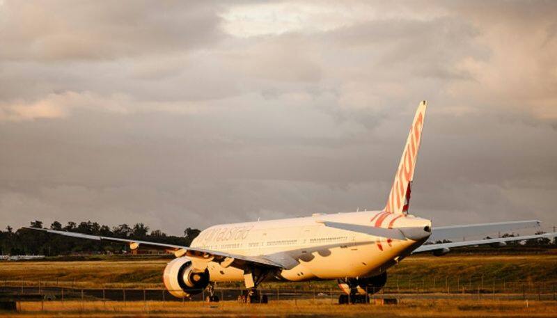 Virgin Australia flight turns back after naked man runs through aisle, knocks down attendant AJR