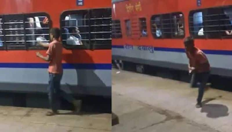 boy snatches phone from moving train video 