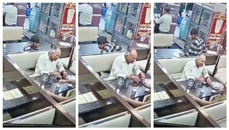 video of a man is caught on camera stealing a mobile phone from a crowded restaurant goes viral