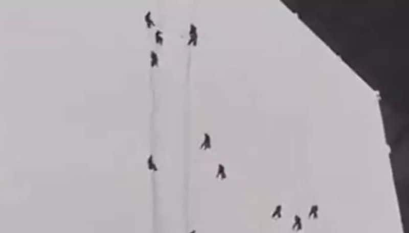 window cleaners hanging from skyscraper 