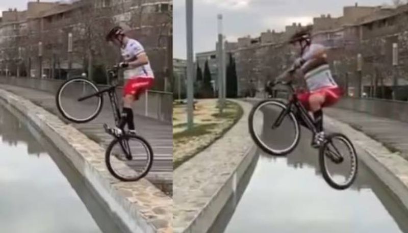 man crosses water body on bicycle video 