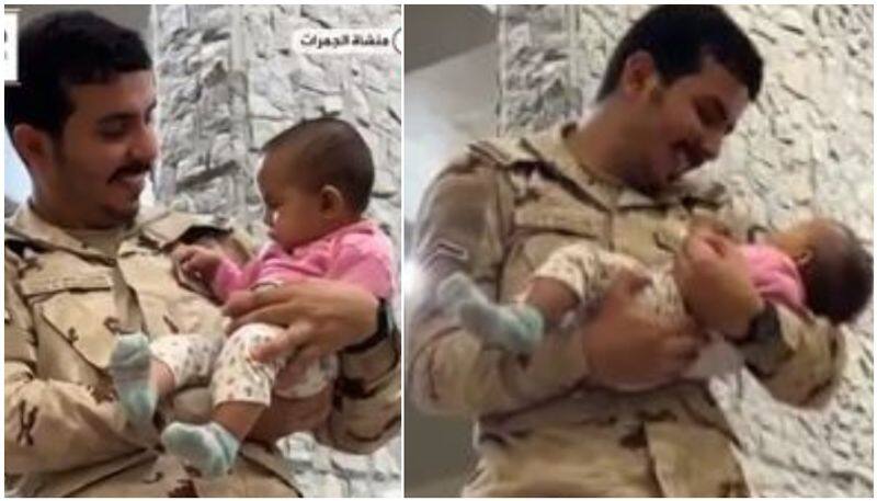 viral video of security man carrying hajj pilgrims baby 