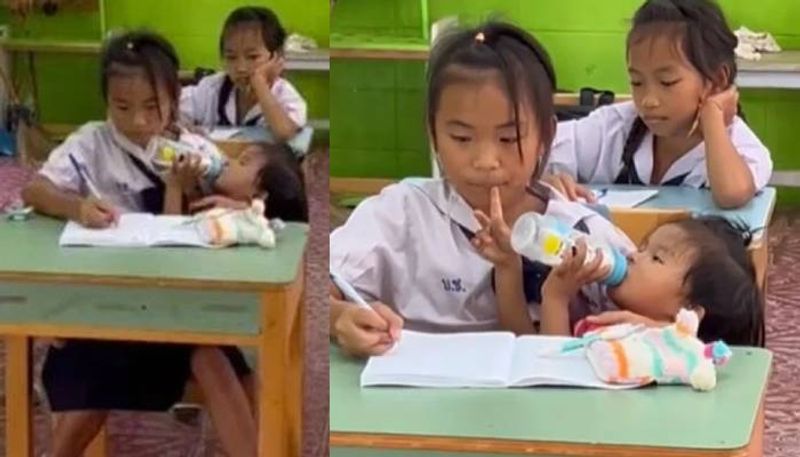 girl caring her little sister while writing notes in class 