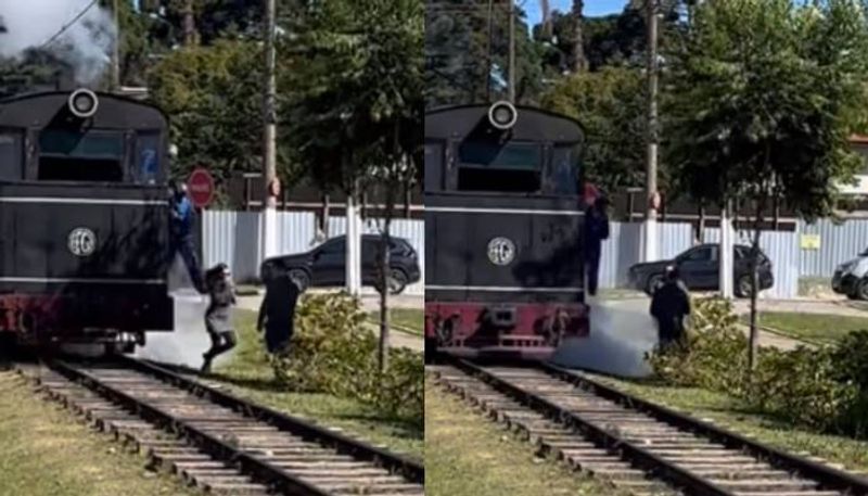 woman posing for photo saves by train driver by kicking her video