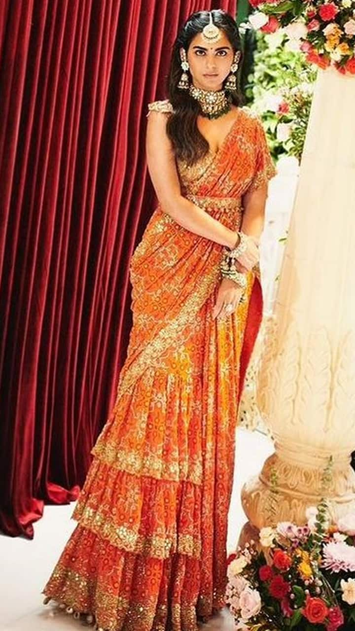 isha ambani lehenga saree wore designer Arpita mehta orange rose gold saree worth one lakh sixty five thousand kxa 