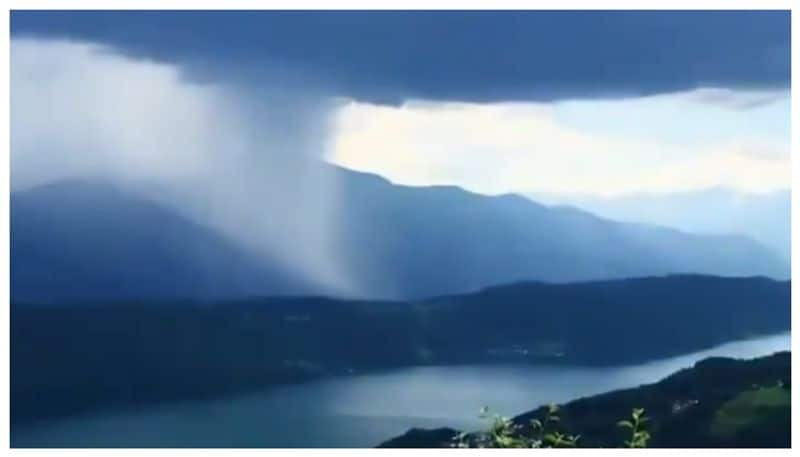 Video of heavy rain falling from clouds over the mountains goes viral 