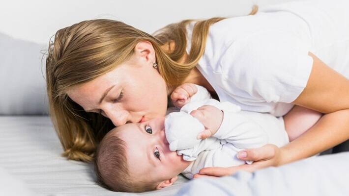 Mother playing with her baby