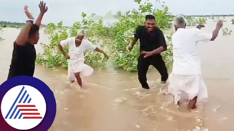 Farmer Father and son due enjoy with traditional dance in water logged area gujarat ckm