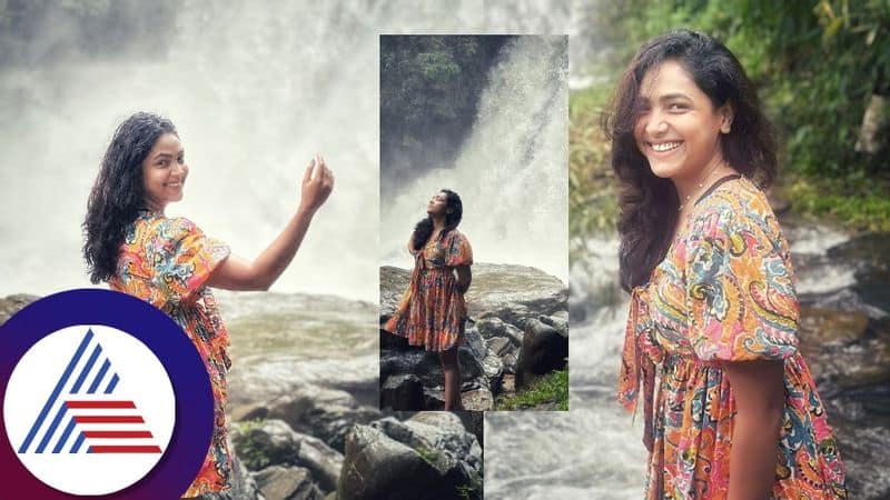 actress television anchor anupama gowda new photoshoot standing in front of waterfall gvd