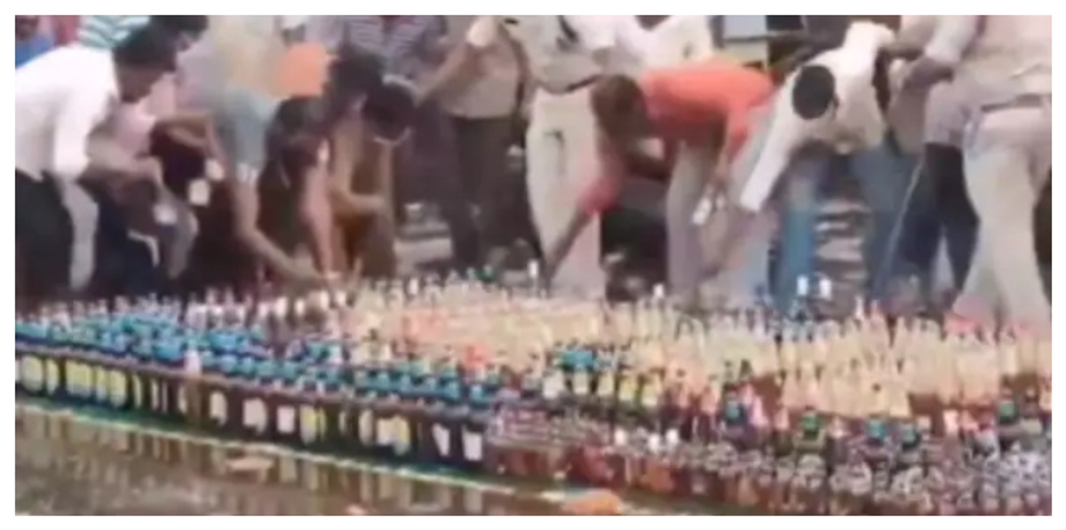 Locals Steal Liquor bottle after Police bring to destroy 