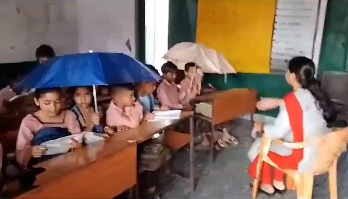 UP Students forced to study under umbrellas due to leaking roof in Baghpat school, concerns raised (WATCH) snt