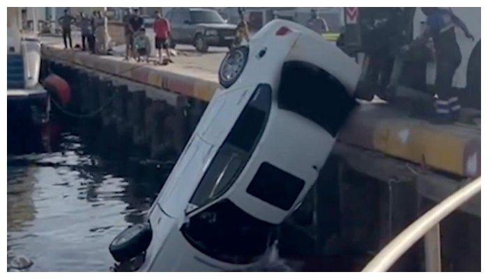 two escaped after car plunges into water and crashes into yacht