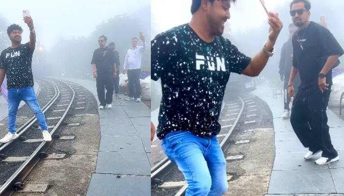 man taking selfie in front of toy train