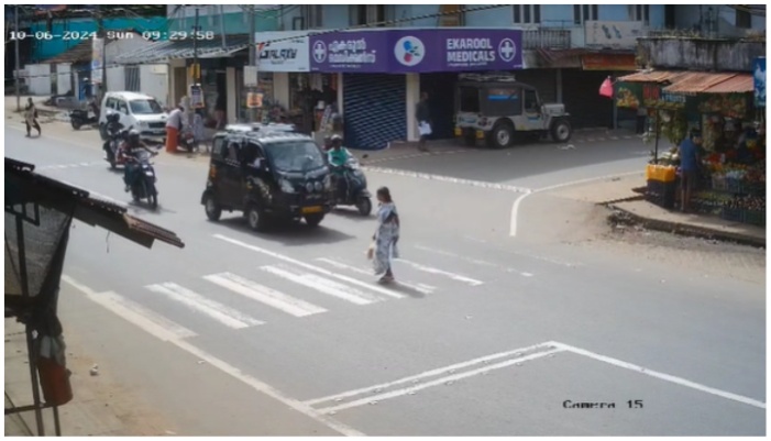 woman hit by a bike while crossing the road through designated pedestrian crossing