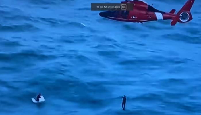 man clinging to a cooler in  Hurricane Milton rescued by Coast Guard pilot and team 