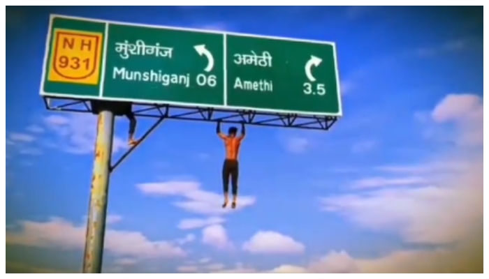 video of a man climbs 20 feet high signboard in Amethi goes viral in social media 