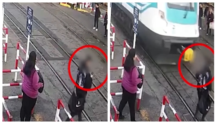 video of an escape has gone viral while talking on the phone and crossing the railway track