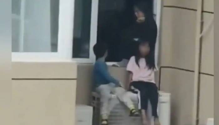 Chinese mother forced children to sit ac unit on their 23rd floor apartment after an argument with husband