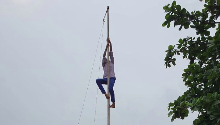 plus two student asked to clim up on flag post