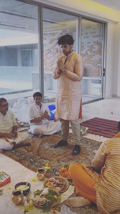 Karan's house has a large hall with a city view.
