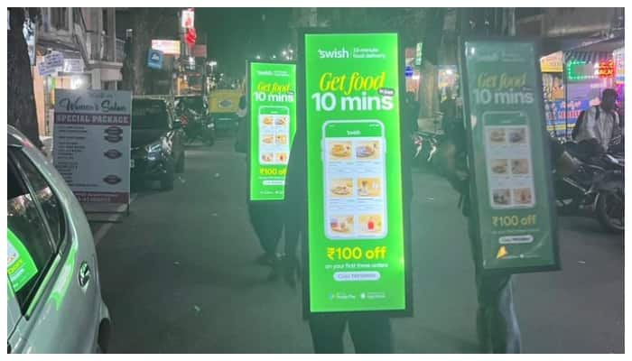 The image of men carrying billboards in Bengaluru city is disturbing on social media