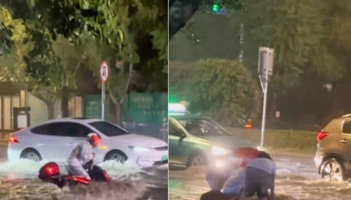 man stuck in flood with his scooter strangers helps him heartwarming video 