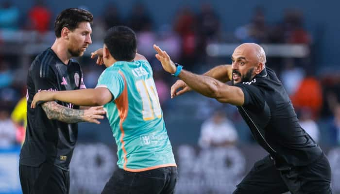 Lionel Messi's bodyguard Yassine Chueko finally beaten after being floored by a pitch-invader who touches Messi