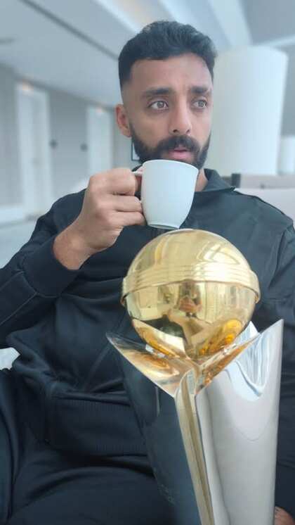 Varun Chakravarthy celebrates with the Champions Trophy