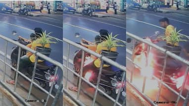 unexpected incident at mannarkkad that the Baby in front of scooter catches fire while parking on roadside and talking on phone unexpected incident at mannarkkad that the Baby in front of scooter catches fire while parking on roadside and talking on phone
